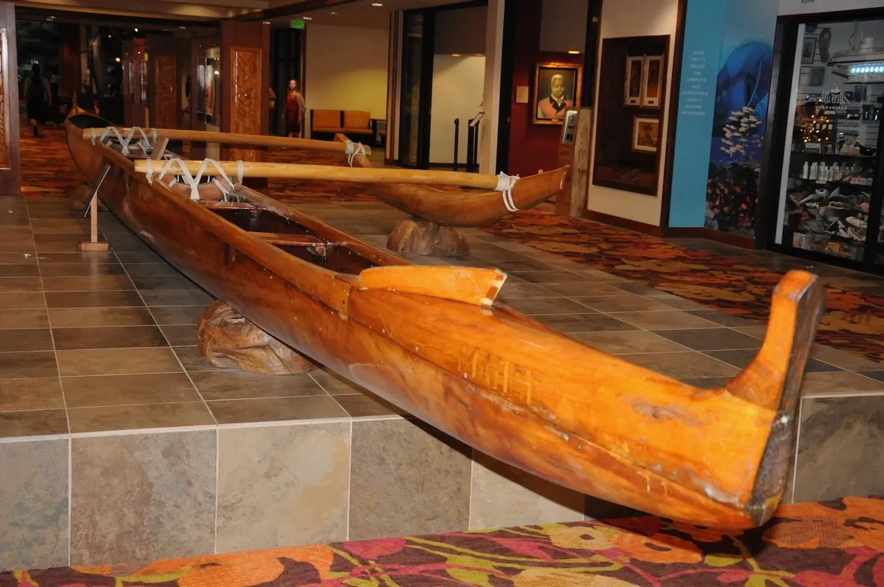 A wooden plane sitting on top of a floor.