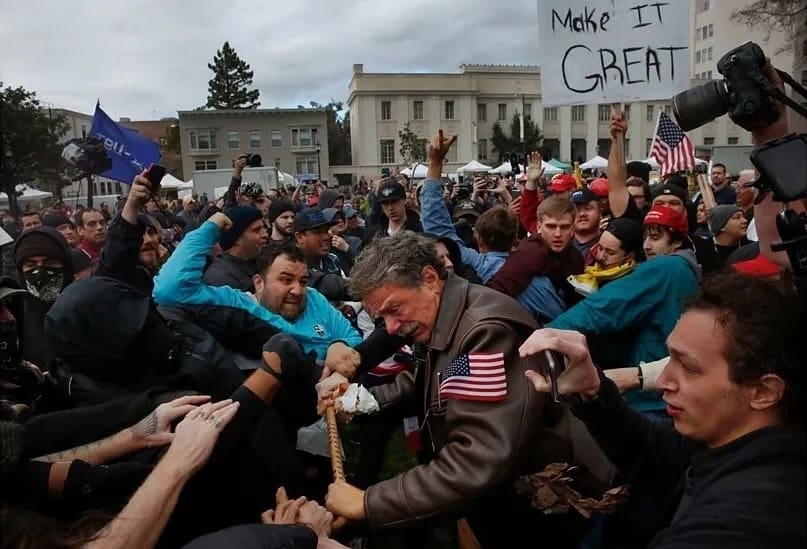 A crowd of people are gathered around a man.